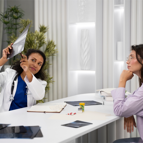 Woman receiving preventive healthcare consultation from a female doctor under medical supervision